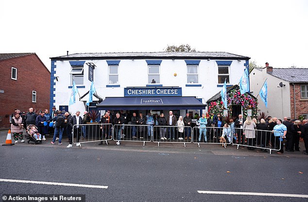 Mourners outside the Cheshire Cheese pub - Hatton's local - on Stockport Road in Hyde
