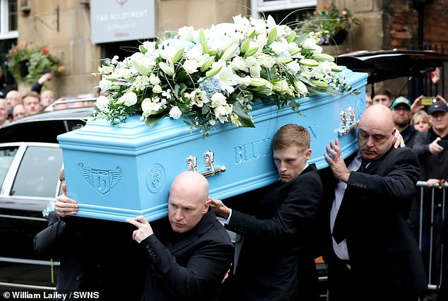 Many mourners placed flowers and tributes on the low-loader transporting the vehicle. Ricky's body was in a blue coffin with 'Blue Moon' etched on the side.