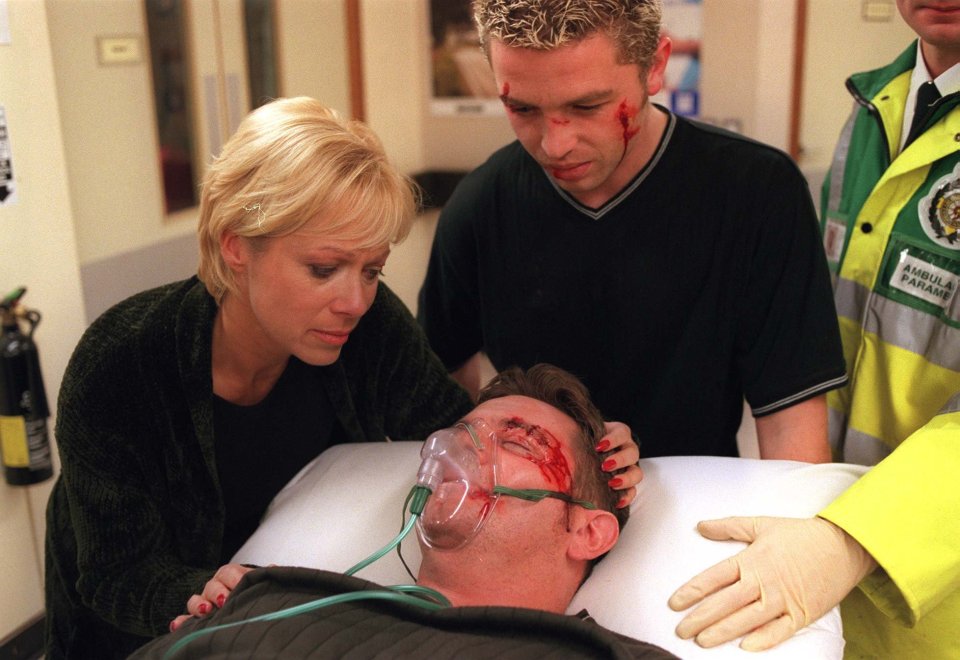 Tony (Lee Warburton) and his mother Natalie (Denise Welch) look on as Des Barnes (Phil Middlemiss) is taken to Weatherfield hospital after a brutal attack.
