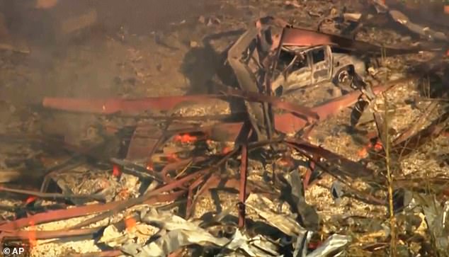 Debris covers the ground and vehicles after a powerful blast ripped through a military explosives manufacturing plant in Hickman County, Tennessee