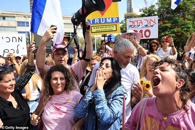 Israelis celebrate as they react to the news of the Gaza peace deal at Hostages Square on October 9 in Tel Aviv, Israel