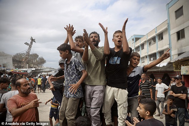 Palestinians, including children, gathered in the city of Khan Yunis celebrate after the announcement of the ceasefire agreement in Gaza on October 9, 2025