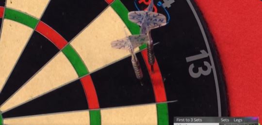 Three darts thrown by Gerwyn Price hit a dartboard.