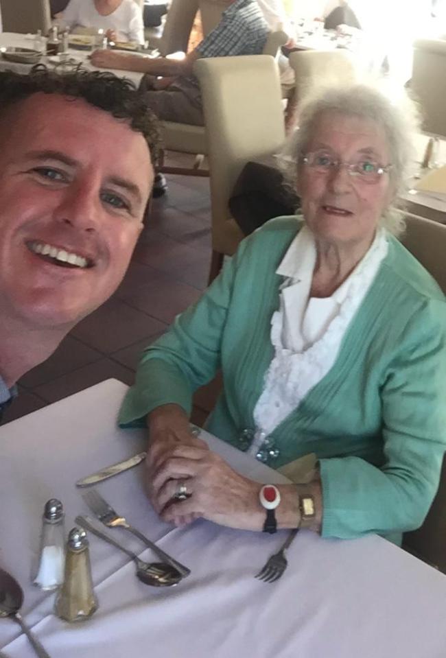 Joan Green and her grandson David Bolton seated at a table.