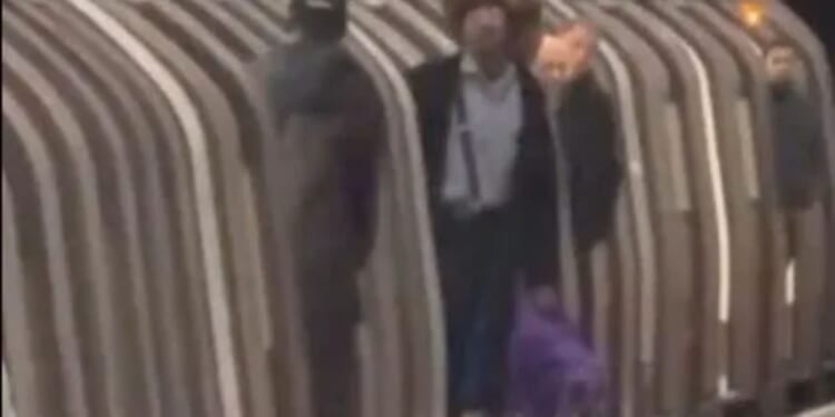 Moment stubborn cyclist refuses to move bike from train in standoff with staff as frustrated passengers watch on