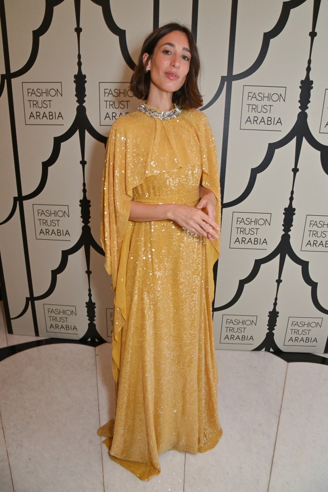Laura Jackson attending the Fashion Trust Arabia London dinner in a gold sequined gown with a silver embellished neckline.