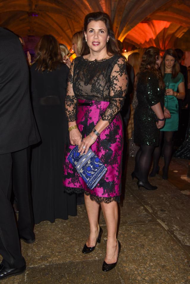 Kirsty Allsopp attending Save the Children's Winter Gala in a black lace top, magenta and black skirt, and holding a blue patterned clutch.