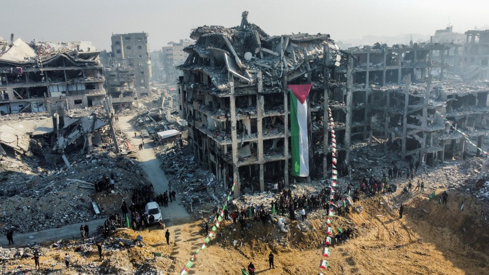 Drone view of a Palestinian flag on a damaged building in Jabalia.