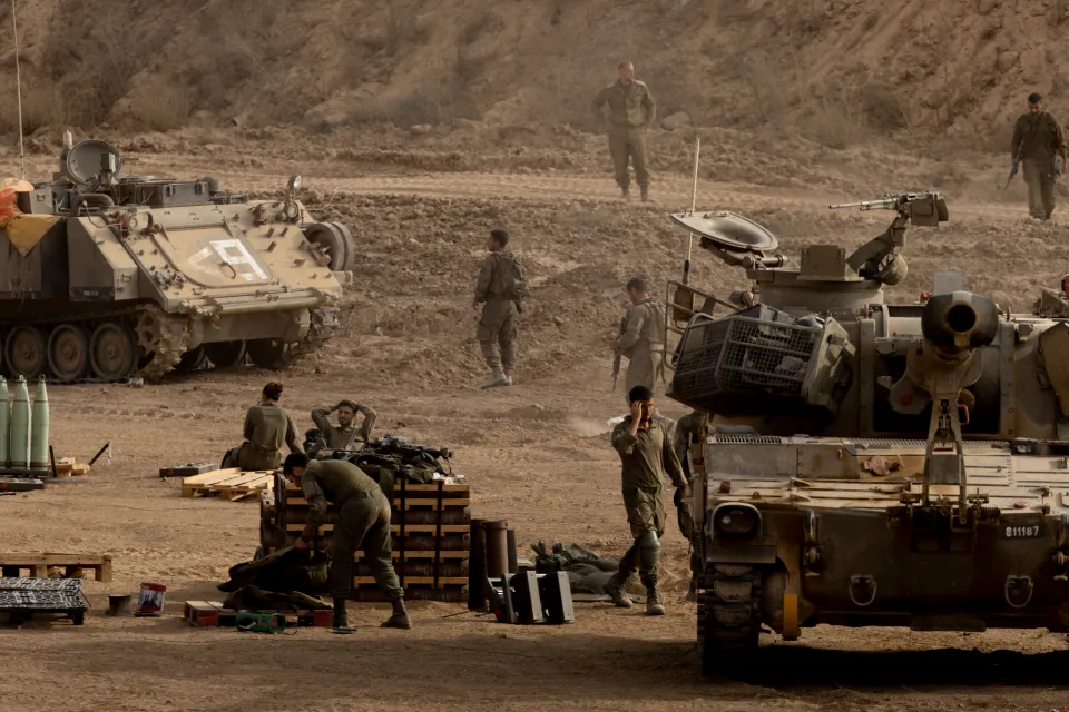 Israeli soldiers resting near artillery units near the Gaza Strip border.