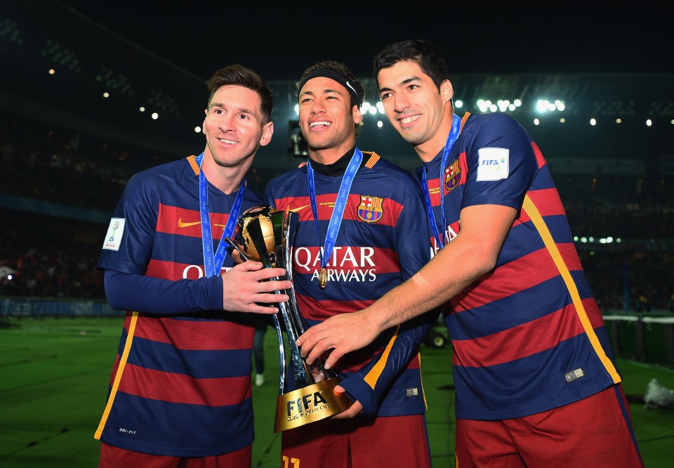 Lionel Messi, Neymar, and Luis Suarez holding the FIFA Club World Cup trophy.