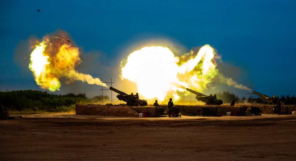 Taiwanese military personnel fire howitzer ammunition during a joint anti-landing drill.