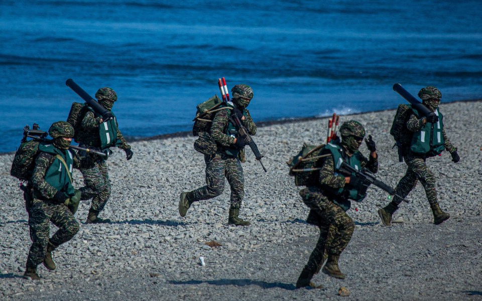Soldiers disembark from AAV7 amphibious assault vehicles during the Han Kuang military exercise in Pingtung, Taiwan.