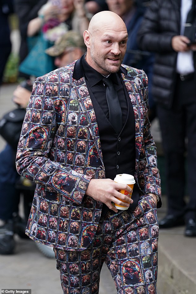 Clutching a McDonalds coffee, Fury showed off his matching suit and pants, with images depicting him on a throne wearing a crown