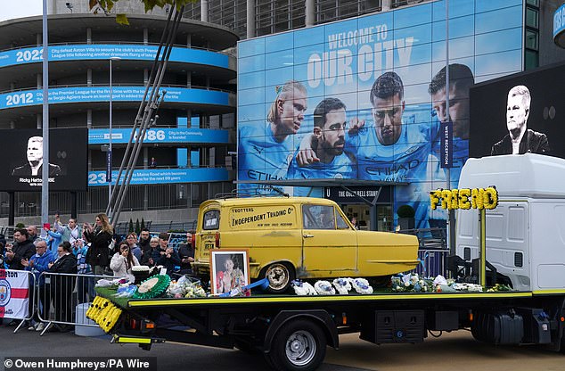 Hatton's three-wheeled Reliant Robin in the procession arriving at the Etihad Stadium