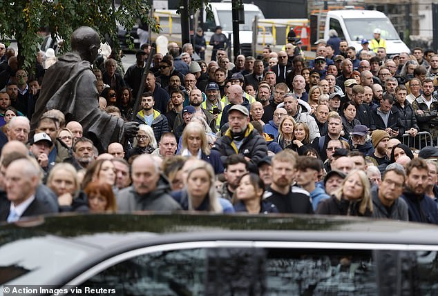 Mourners look on as the funeral cortege of Ricky Hatton passes by in Manchester on Friday