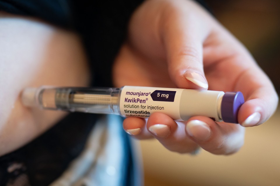 A Mounjaro KwikPen injection pen being used on a woman.