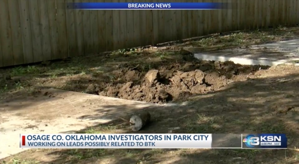 Dug-up ground next to a wooden fence, with text overlay "OSAGE CO. OKLAHOMA INVESTIGATORS IN PARK CITY WORKING ON LEADS POSSIBLY RELATED TO BTK".