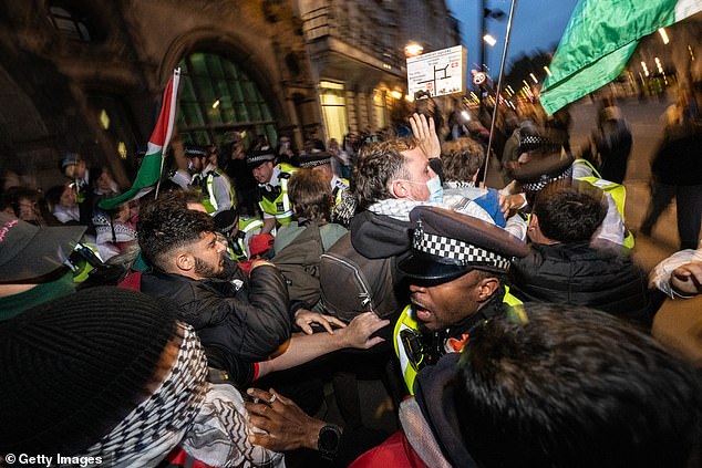 Police scuffle with Pro-Palestine protesters at the south end of Whitehall following a protest in Parliament square on Thursday, October 2