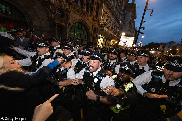 Police were seen scuffling with protesters at the south end of Whitehall following a protest in Parliament Square on the day of the terror attack