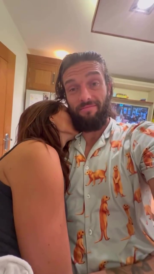 Andy Carroll and Lou Teasdale together, with Teasdale kissing Carroll on the cheek.