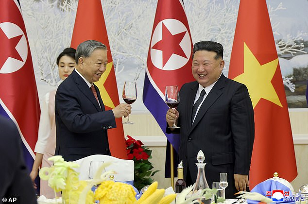 In this photo provided by the North Korean government, Kim Jong Un, right, and Vietnamese Communist Party General Secretary To Lam, left, at a reception at the headquarters of the ruling Workers's Party, in Pyongyang, North Korea