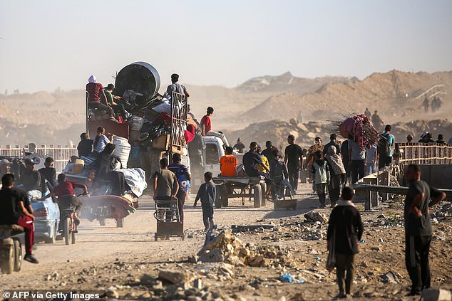 Palestinians make their way to Gaza City through the so-called "Netzarim corridor" from Nuseirat in the central Gaza Strip on October 11, 2025