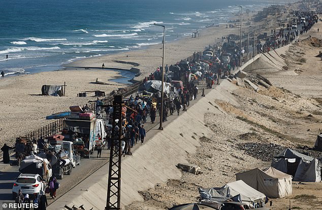 Palestinians, who were displaced to the southern part of Gaza at Israel's order, make their way along a road as they return to the north, amid a ceasefire between Israel and Hamas in Gaza, in the central Gaza Strip, October 11, 2025