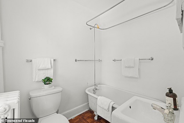 An all white bathroom in the property with a free-standing bath is seen above