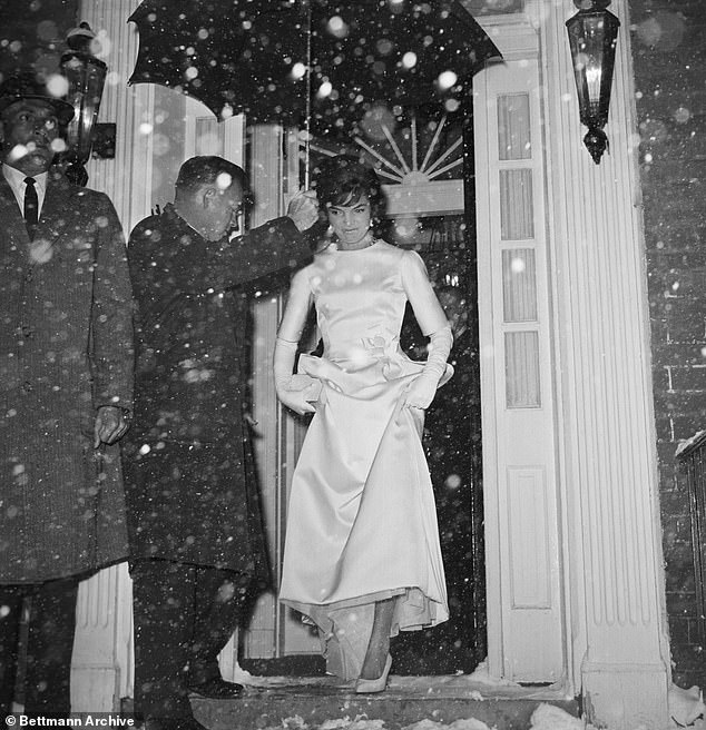 Jackie Kennedy stepping out into a snowy night from her Georgetown home as she heads to the pre-inauguration gala in 1961