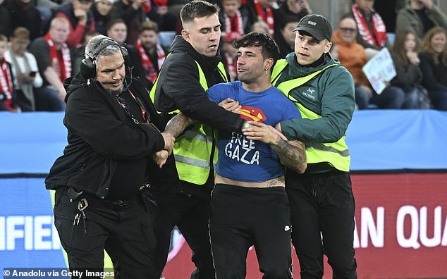 One football supporter ran on to the pitch wearing a 'Free Gaza' t-shirt as he was escorted out