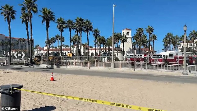 Two people were on board the ill-fated helicopter and both were removed safely. However, three people on the ground were injured and transported to a nearby hospital. Pictured: Emergency response teams report to the crash site in Huntington Beach, California