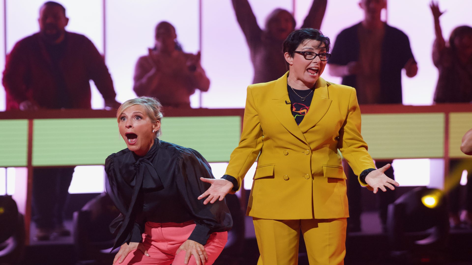 Mel Giedroyc and Sue Perkins reacting in surprise on the show 'Win Win with People's Postcode Lottery'.