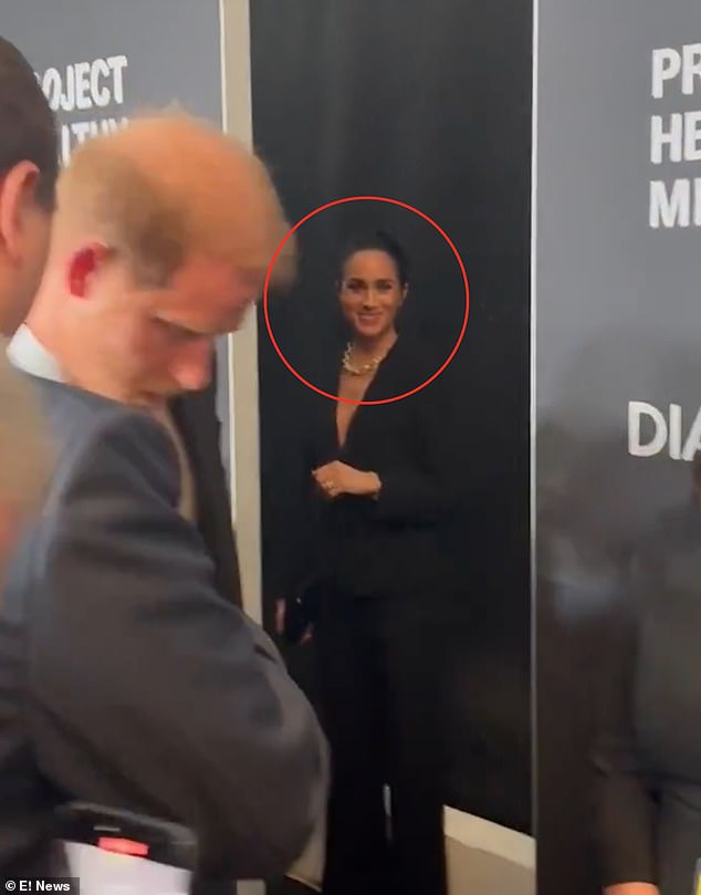 Meghan was left waiting when Harry spoke to someone by the red carpet