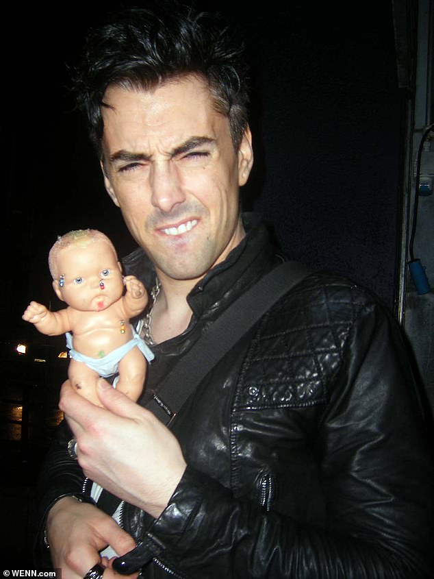 Pictured: Ian Watkins holding a baby doll in 2010. He pleaded guilty to 13 sex offences, including the attempted rape of a baby in 2013
