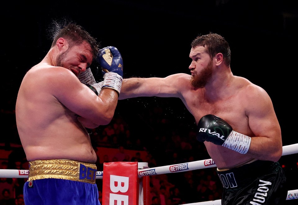 Arslanbek Makhmudov punching Dave Allen during a boxing match.