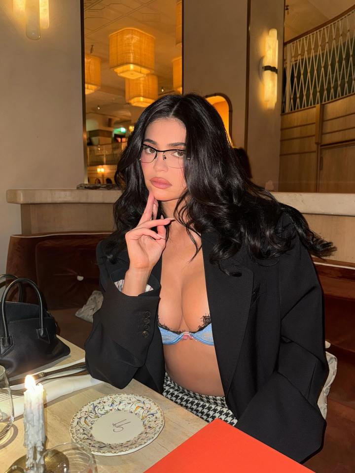 Kylie Jenner in a bra and black blazer for a night out in Paris.