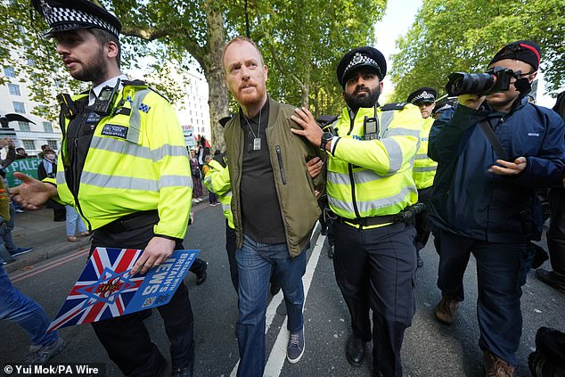 Pictured: Police officers lead away a demonstrator from Our Fight, a pro-Israel organisation, ahead of a Palestine Solidarity Campaign march from Victoria Embankment to Downing Street, central London