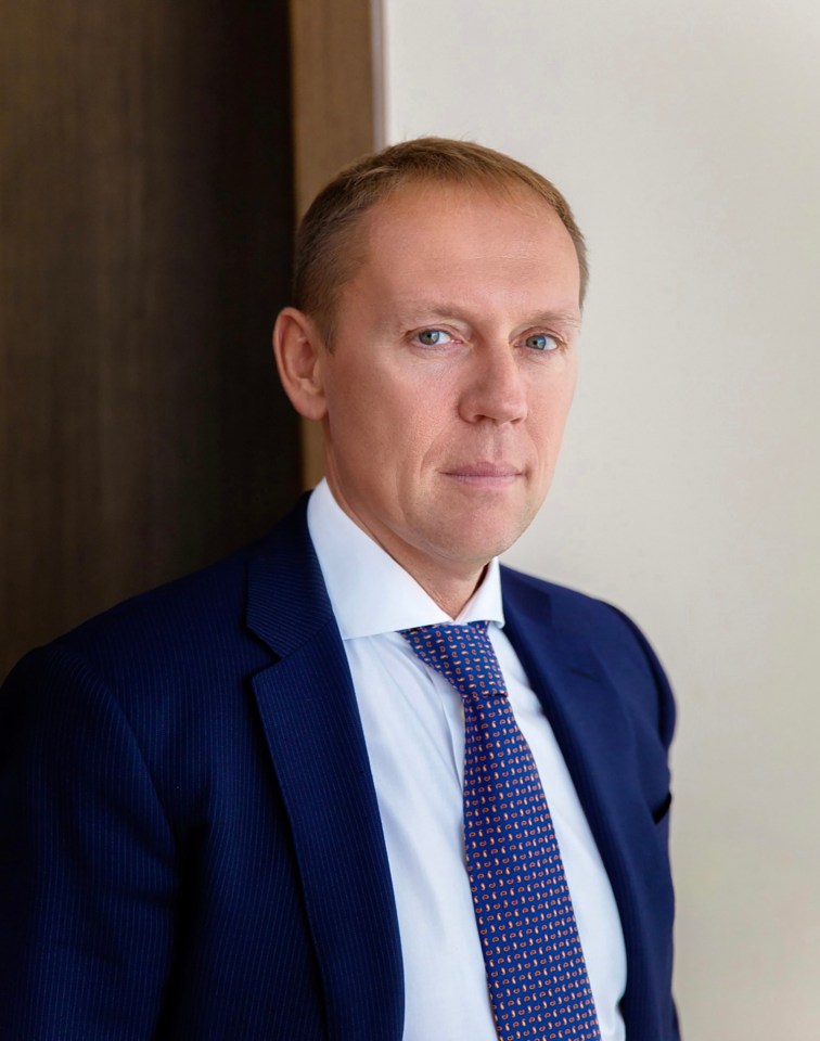 Andrey Lugovoy, a Putin-backing MP, wearing a dark blue suit and a blue and orange patterned tie.
