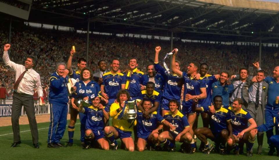The Wimbledon team celebrates with the FA Cup trophy at Wembley Stadium.