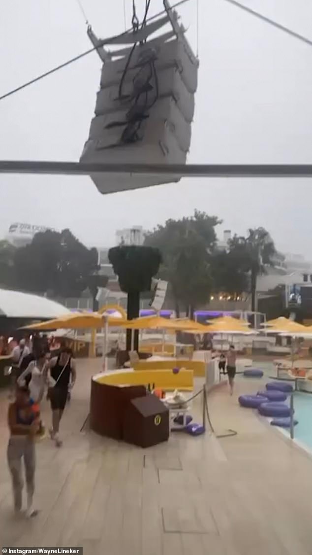 Revellers at the beach resort could also be seen running to shelter as the storm continued