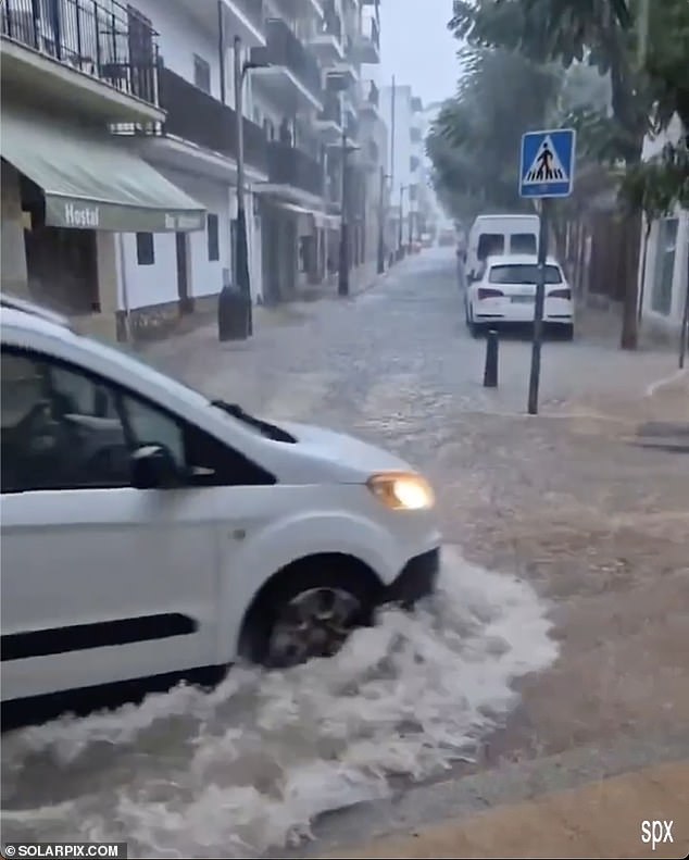 Vans and four-by-four vehicles struggled to make their way through the flood-hit roads
