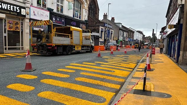 The large orange and yellow lozenge-shaped designs (pictured) have been painted on to Grange Road West in the centre of Birkenhead, Merseyside