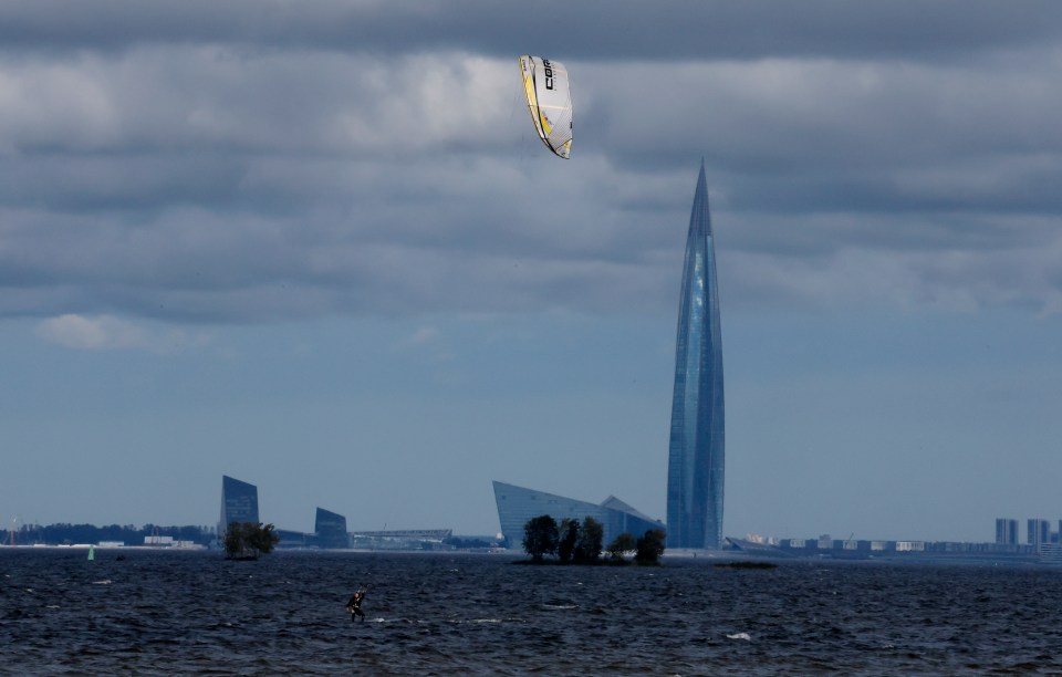 A kitesurfer in the Gulf of Finland with the Lakhta Centre tower in the background.