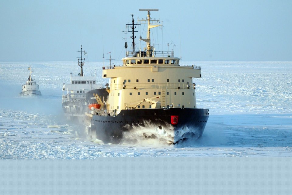 Icebreaker Apu cutting through icy waters, followed by another vessel.