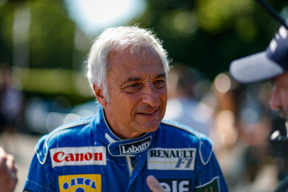 Riccardo Patrese in a blue racing suit with sponsors including Canon, Labatt's, and Renault F1, at the Goodwood Festival of Speed.