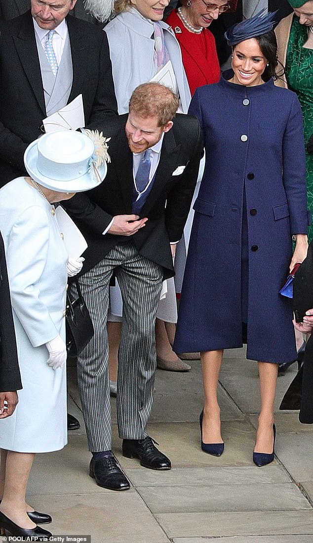 Prince Harry and Meghan speak with the Queen outside the chapel. It was during the celebrations that they told her about the duchess's pregnancy