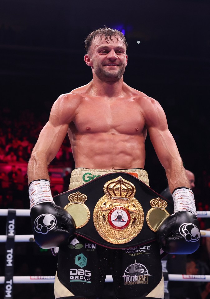 Josh Padley holds his championship belt after defeating Reece Bellotti.