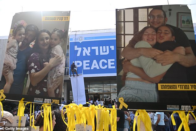 Signs of hostages and one's that says 'Peace Israel' are seen outside on Sunday in Hostages Square