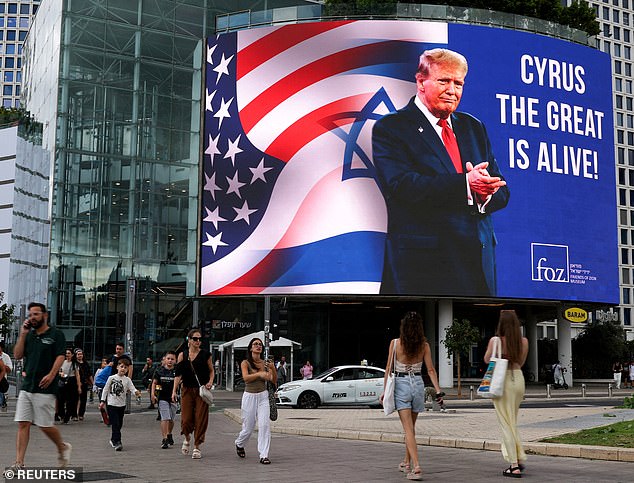 A huge billboard of Trump is seen in Tel Aviv, Israel on Sunday. The president is set to fly to Tel Aviv and Egypt around 3pm EST today