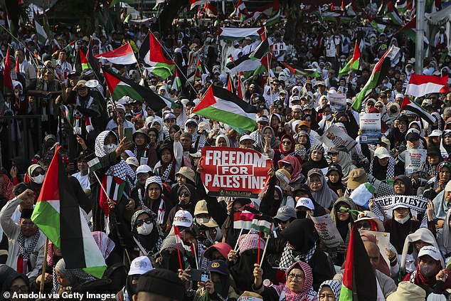 Thousands of demonstrators are seen gathered near the National Palace to express solidarity with Palestinians during an anti-Israel rally in Jakarta, Indonesia, on Sunday